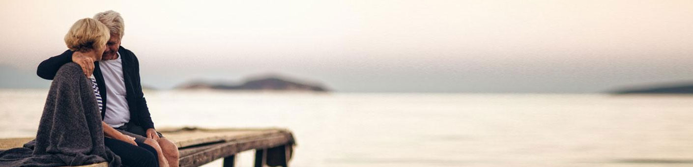 Senior couple sitting on a dock