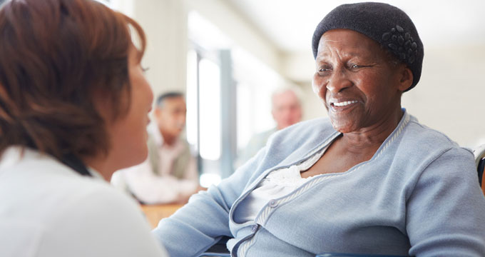 Senior speaking with healthcare professional